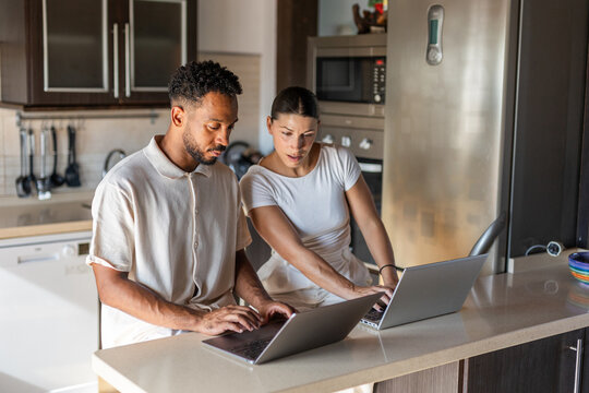 A couple working from their kitchen at home