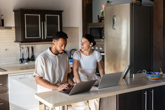 A couple working from their kitchen at home