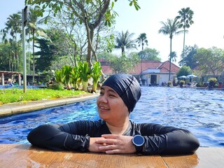 Asian woman wearing swimming cap also wearing smartwatch for activity tracker for active lifestyle
