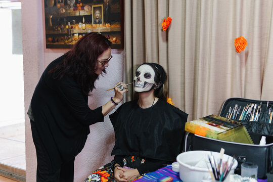 Lady applying creepy Halloween makeup
