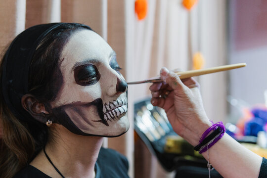 woman getting made up for halloween