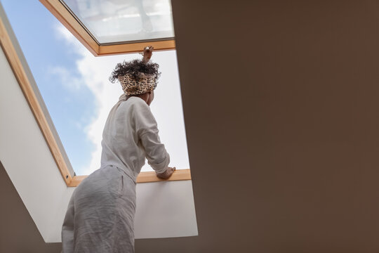 Woman opening window