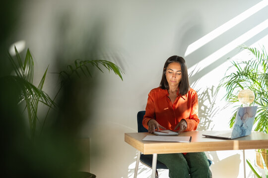 Candid businesswoman working at office