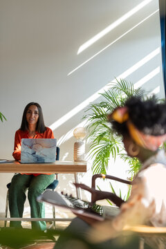 Colleagues talking at office
