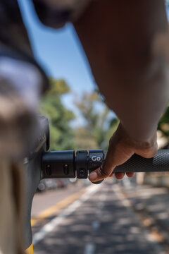 Woman pressing throttle button on e-scooter