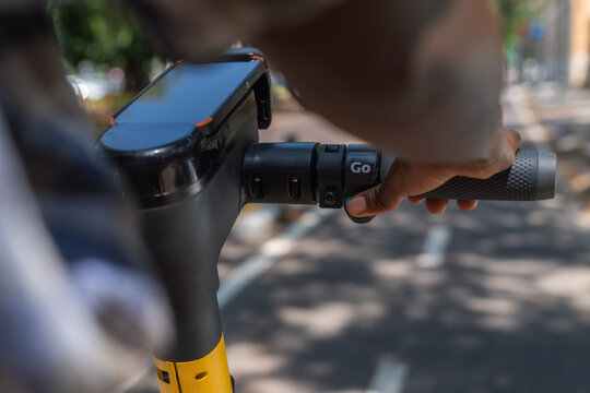 Young black woman accelerating on e-scooter