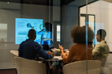 Business analyst explaining statistical data to colleagues