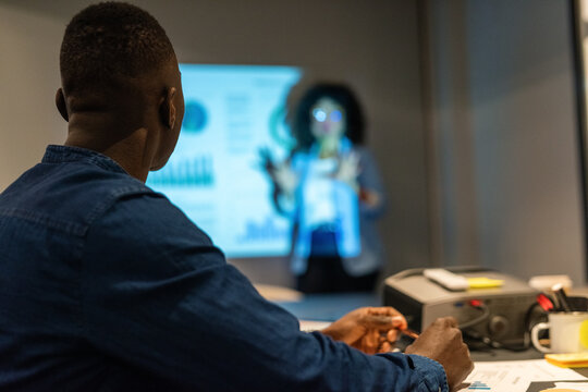Man listening to a colleague at presentation