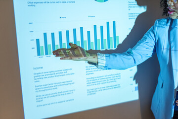 Businesswoman presenting financial results of company on screen