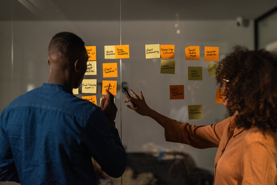 Colleagues planning assignments in meeting room