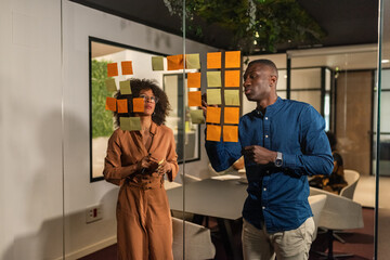 Business people taking notes while brainstorming at office