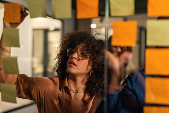 Young professional at briefing with her colleague 