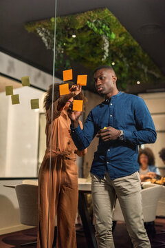 Focused colleagues discussing ideas in meeting room