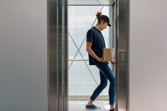 Candid courier using elevator 