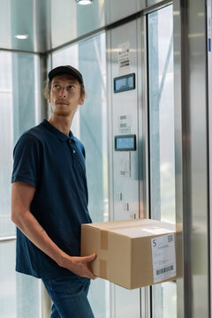 Courier in elevator watching floor counter screen