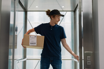 Courier holding box and pressing button in elevator