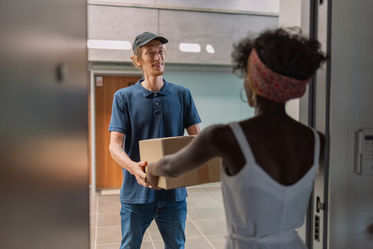 Courier delivering parcel to customer door