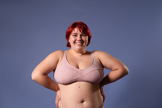 Confident plus size woman posing at studio