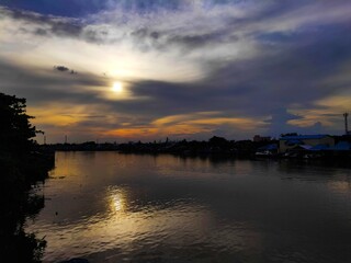Blue and Orange Sky of Sunset Views at Martapura River in Afternoon, Use as a Background and Wallpaper