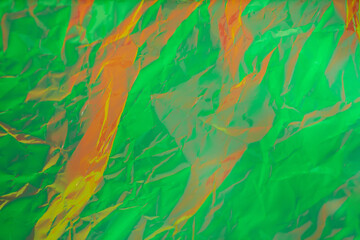 Crumpled surface of neon green and orange tones