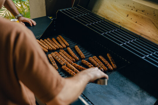 Grilling sausages outside bbq