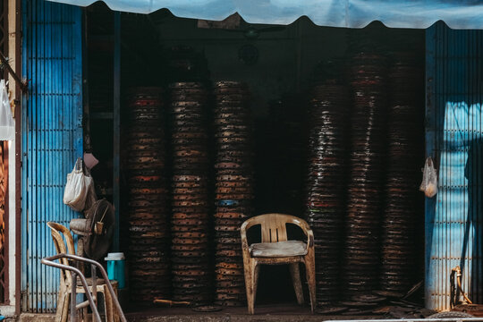 A Chair Among Stacked Metal Plates