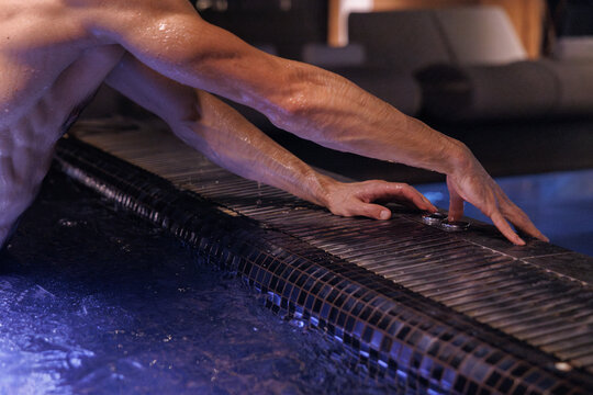 Partial view of man pushing button for call service in jacuzzi pool