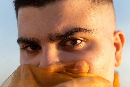 Eyes of non binary person at sunset close up portrait