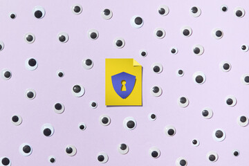 Paper keyhole in the middle of composition with many eyes