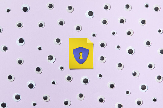 Paper keyhole in the middle of composition with many eyes