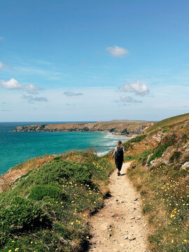 Woman walking along coastal pathway