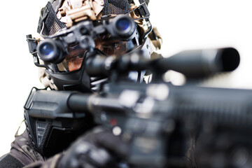 Tactical operative in advanced gear aiming weapon for a mission