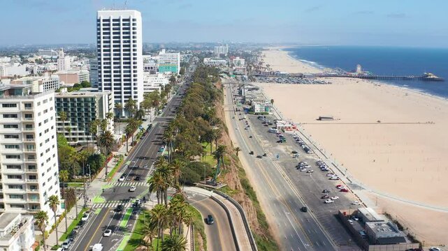 Aerial wide view of Santa Monica Los Angeles beach coast road cars palm trees 