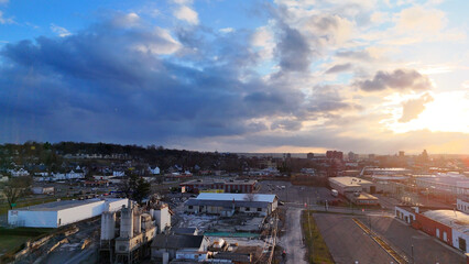 Fototapeta premium Aerial View of the Syracuse City Skyline and the network of it's roads as the sun begins to set over it.