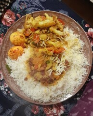 Fried eggs with rice, cauliflower, and lentil curry. Traditional Bangladeshi delicious and healthy food.