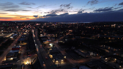Naklejka premium Aerial View of the Syracuse City Skyline and the network of it's roads as the sun sets.