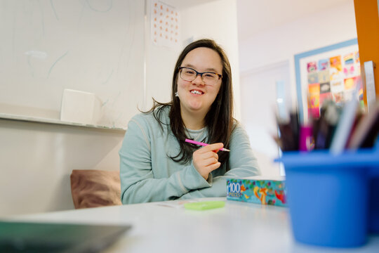 Smiling Person Drawing in Creative Classroom Setting.