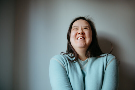 Joyful Portrait of a Smiling Individual in a Calm Indoor Setting