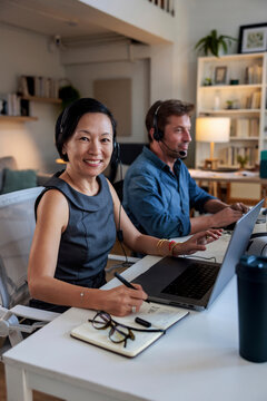 Happy female customer support specialist in office