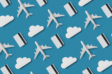 Pattern of credit cards, clouds and air planes on blue background