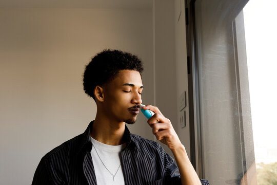 man taking Nasal spray