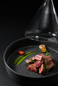 Closeup grilled steak pieces on a plate with exquisite presentation