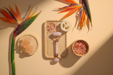 Spa-themed composition with Jade Roller and Tropical Flowers