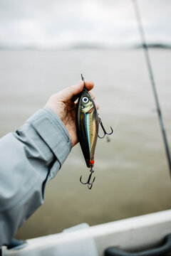 a man holding a fishing lure