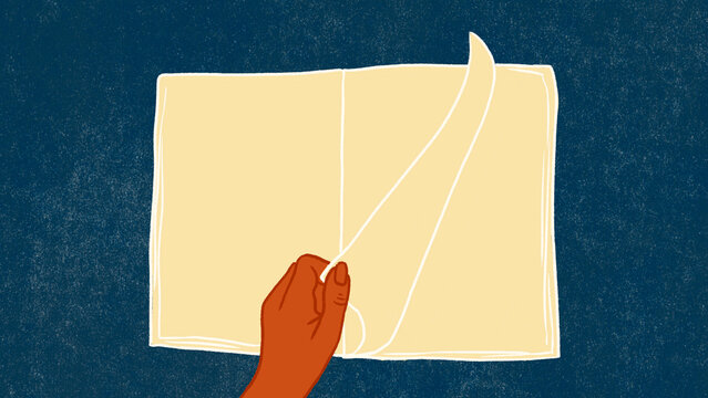 Hand turns the page of a book