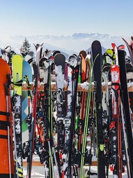 Skis lined up against a snowy mountain backdrop
