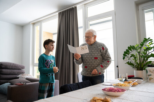Grandfather Reading Birthday Card Written By His Grandson