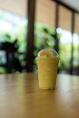 A glass of healthy orange smoothie on table