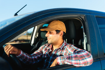 Latin farmer driving pickup truck in countryside