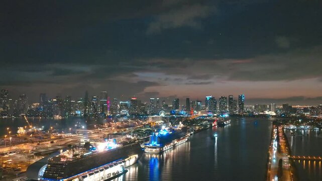 Miami Beach city at night with dramatic sky. Miami Beach seaside at dusk. Aerial view of evening Miami Beach and cityscape. Coastline of Miami Beach city, night shot. American city.